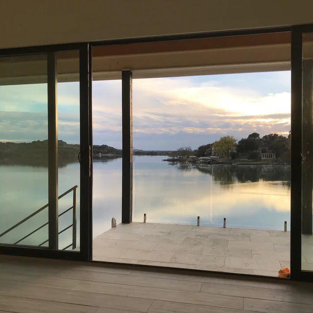 Lakefront glass railing with panoramic water views — Safe and Clear frameless glass fencing