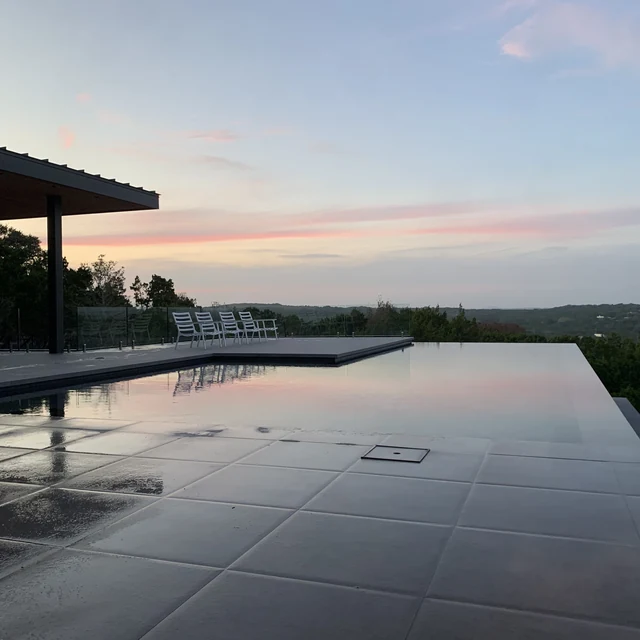 Infinity pool with frameless glass fence overlooking scenic views — Dallas-Fort Worth installation