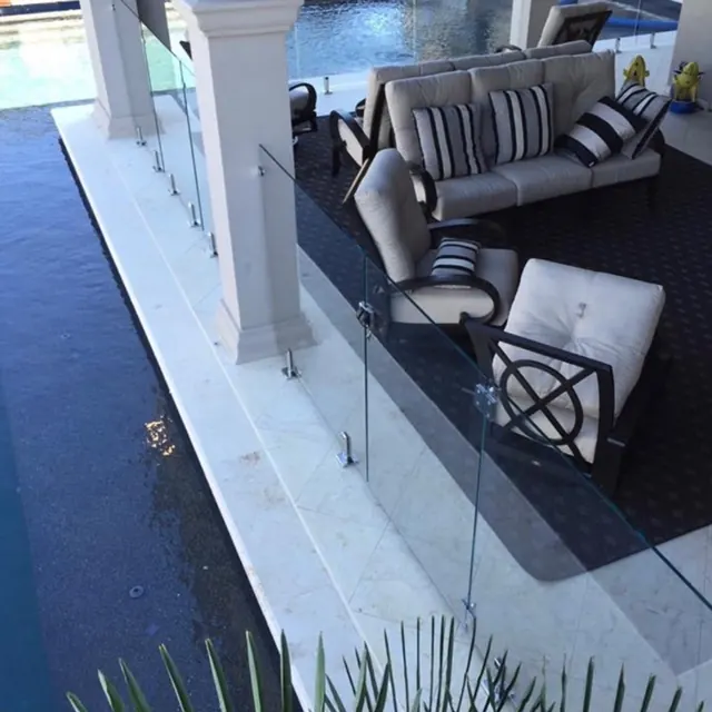 Frameless glass pool fence with patio seating — residential installation Fort Worth TX